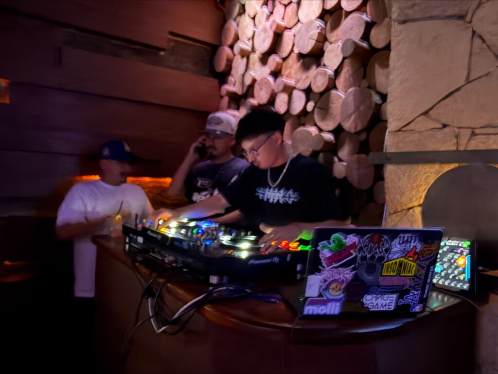 Niko behind the decks with friends at a night set